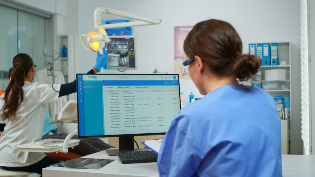 Dental operatory device monitoring dashboard — Divine Logic Dental operatory monitor shows a generic uptime dashboard; interface is blurred for privacy.