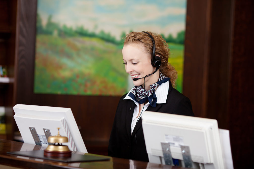 Hotel front desk with monitoring screens and clean copy space Modern hotel front desk with monitoring screens ready for guests.