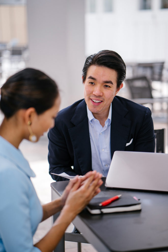 Small team reviews an IT risk checklist with an advisor in a bright, modern office.