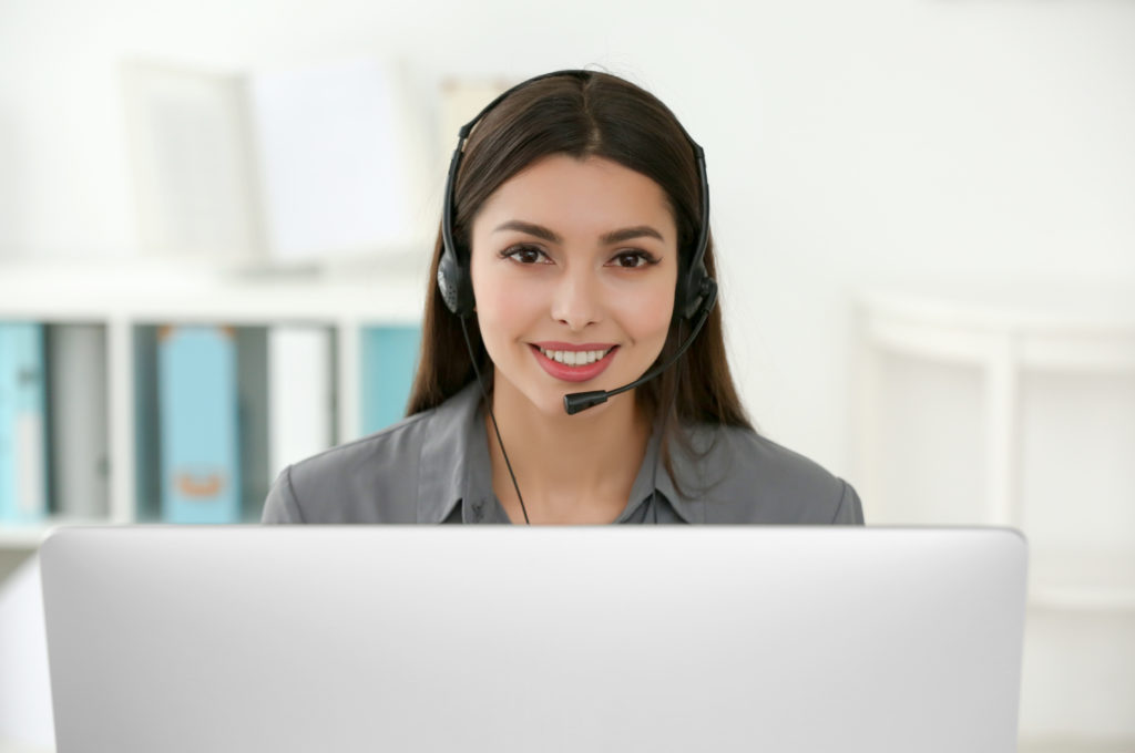 Screen-share in progress with support — Divine Logic A helpdesk agent with a headset monitors a screen-share session icon while assisting vendor support; no details visible.