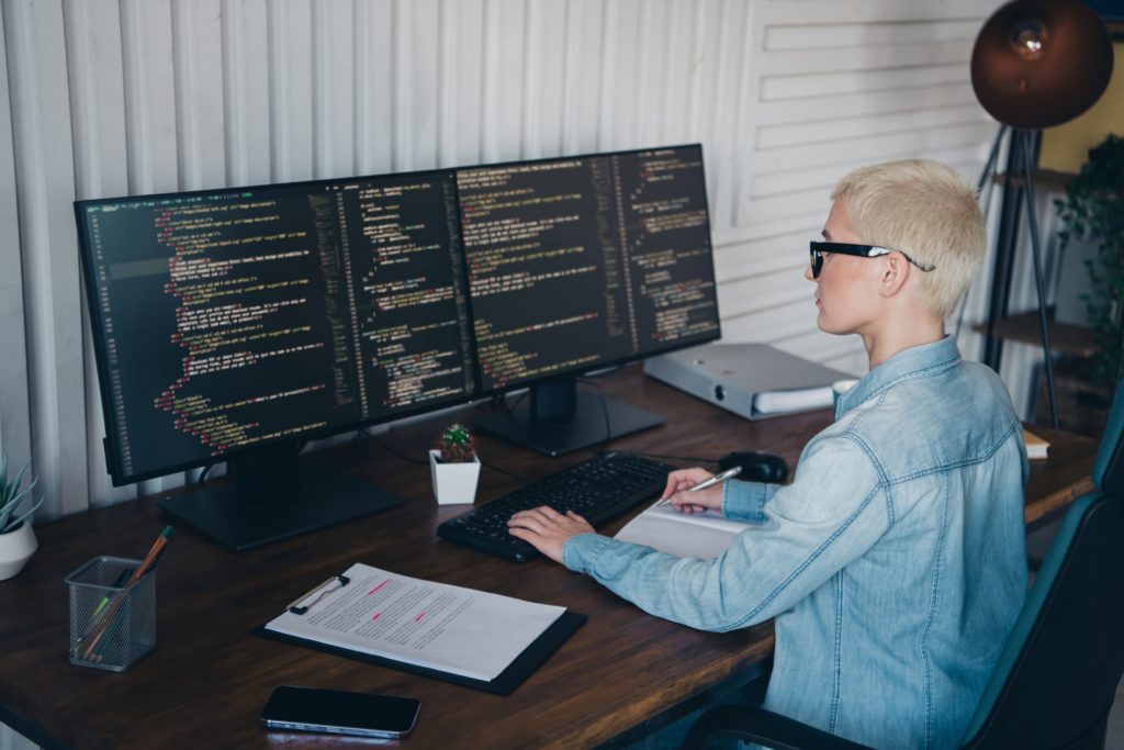 Reviewing security event and audit logs Administrator reviews security event and audit logs on dual monitors.
