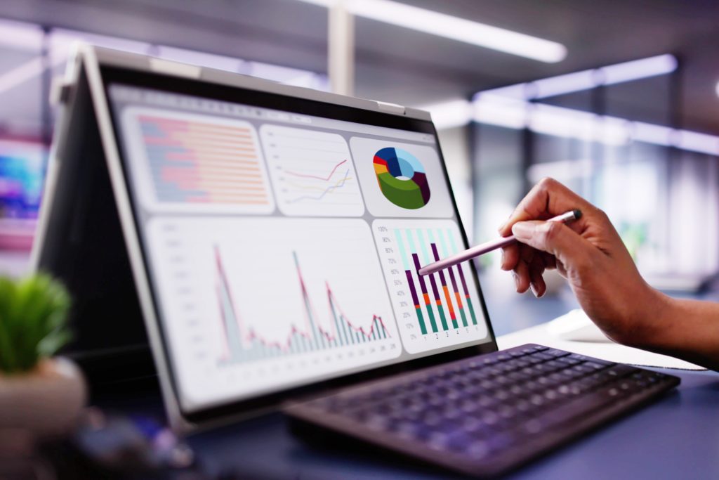Website performance audit on a real device — Divine Logic Laptop on a clean desk with a Lighthouse-style performance audit, neutral office background.